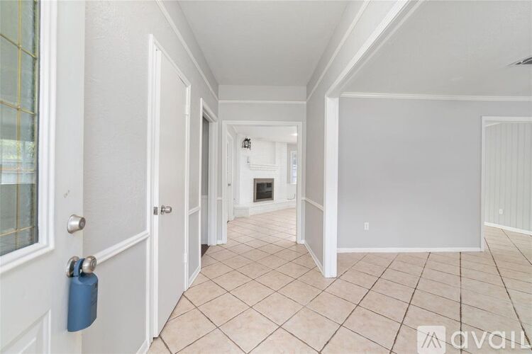 A hallway with a blue lock on the door.