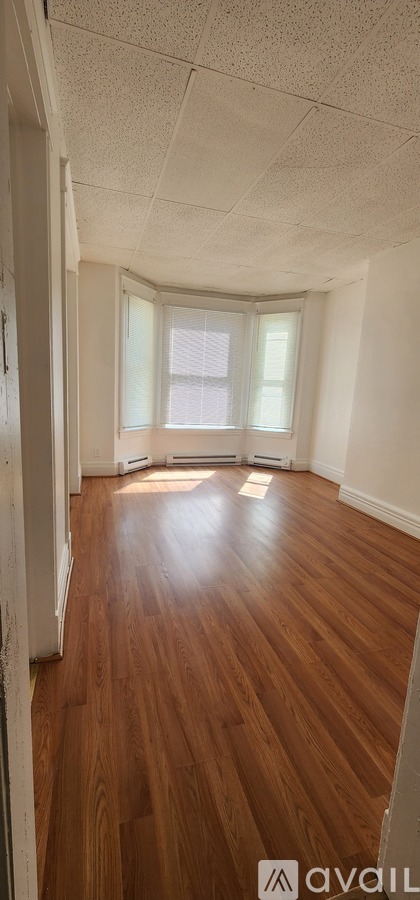 A room with wooden floors and white walls.