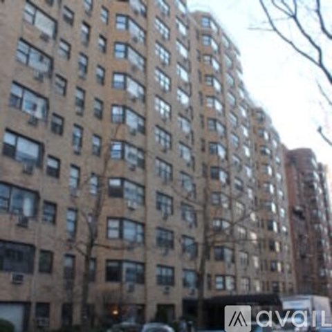 A tall apartment building with many windows and balconies.