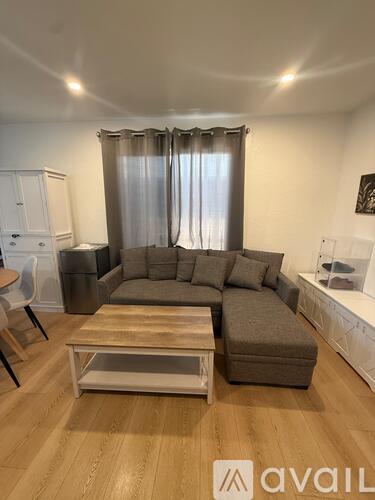 A living room with a grey sofa and a wooden coffee table.
