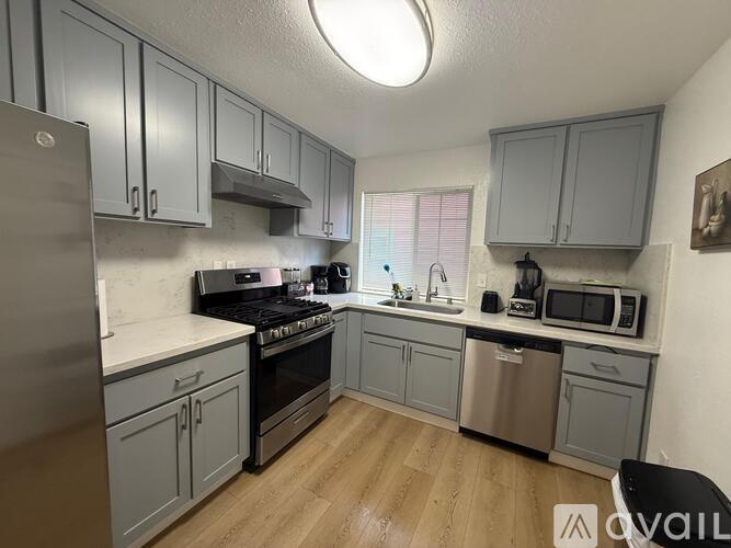 A kitchen with a stove top oven, microwave, and a dishwasher.