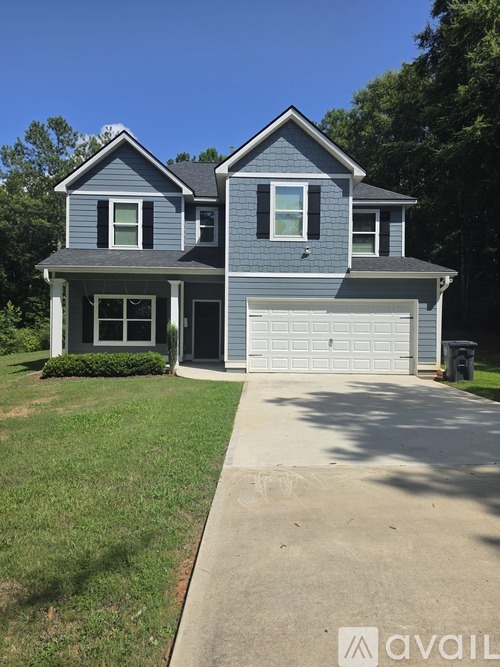 A two-story house with a garage is shown.