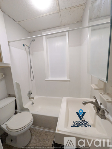 A bathroom with a toilet, sink, and bathtub.