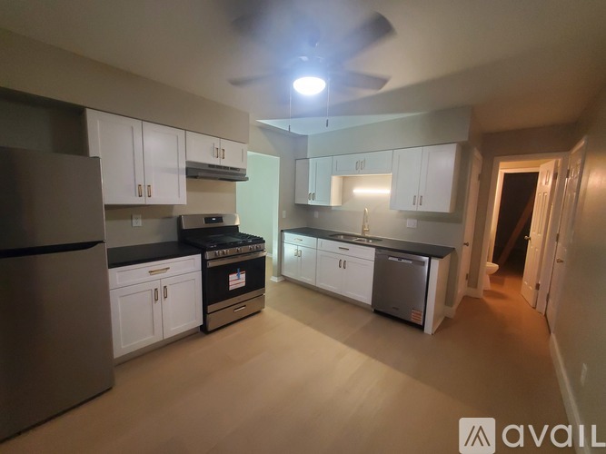 A kitchen with white cabinets and a black stove top oven.