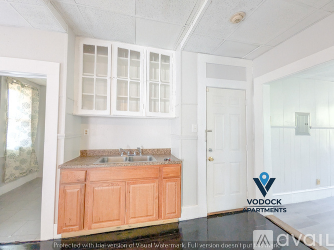 A kitchen with Vodock Apartments logo.