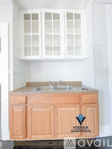 A kitchen with a Vodock Apartments logo on the counter.