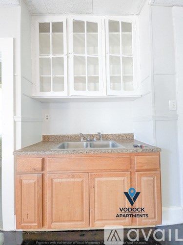 A kitchen with a Vodock Apartments logo on the counter.