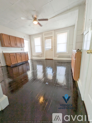 A room with wooden floors and a ceiling fan.