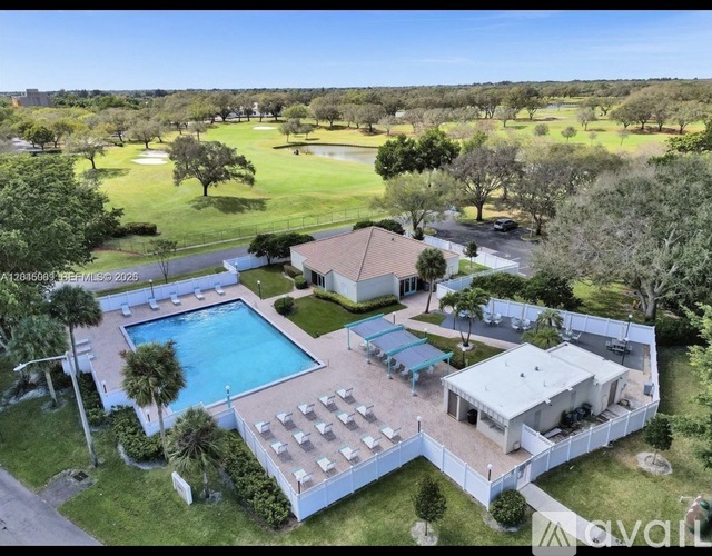 A large house with a pool and a fence.