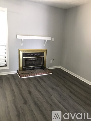 A modern living room with a fireplace and wooden flooring.