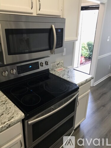 A modern kitchen with a stainless steel oven and microwave.
