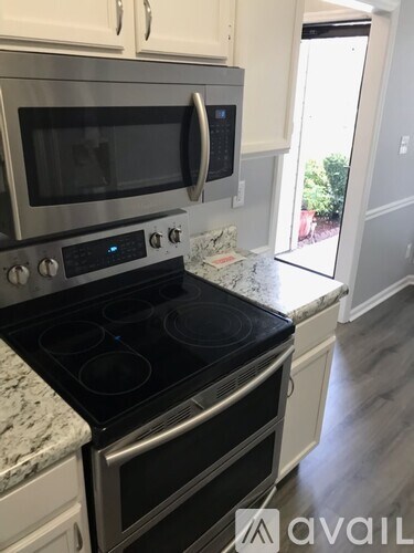 A modern kitchen with a stainless steel oven and microwave.