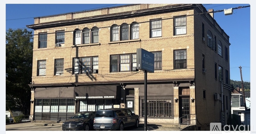 A building with a sign that says "available" in front of it.