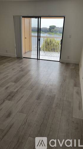 A room with a sliding door leading to a balcony.