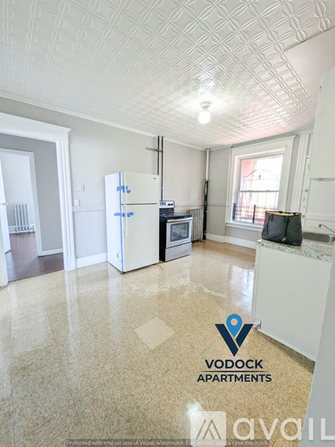 A kitchen with Vodock Apartments logo on the floor.