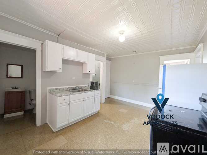 A kitchen with white cabinets and a countertop is shown.