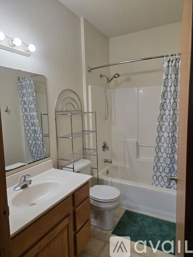 A bathroom with a sink, toilet, and bathtub.