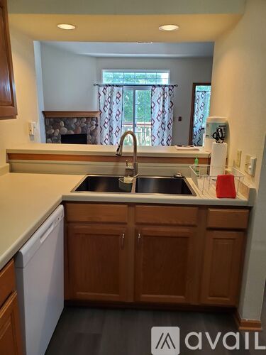 A kitchen with wooden cabinets and a stainless steel sink.