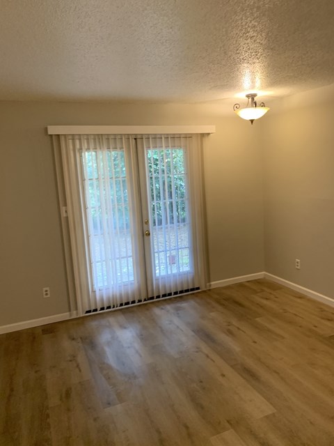A room with a sliding door and a light on the wall.