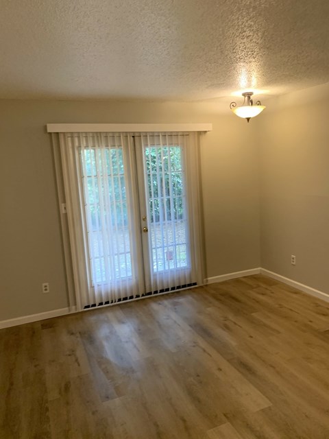 A room with a sliding door and a light on the wall.