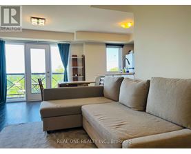 A living room with a couch, chair, and sliding glass doors.