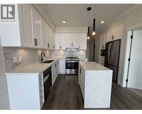A modern kitchen with white cabinets and a central island.