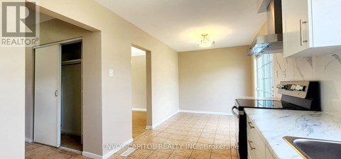 A kitchen area with a sink and a refrigerator.