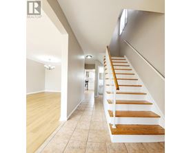 A long hallway with a staircase on the right side.