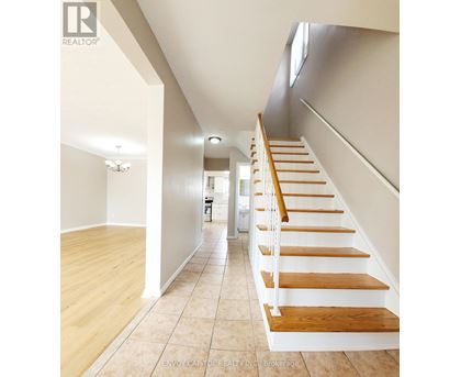 A long hallway with a staircase on the right side.