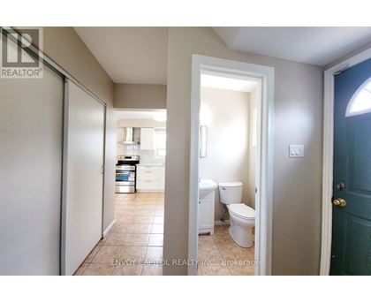 A bathroom with a toilet and sink is shown in the image.