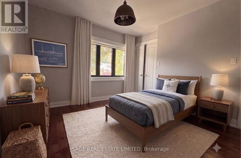 A bedroom with a large bed and a window with curtains.