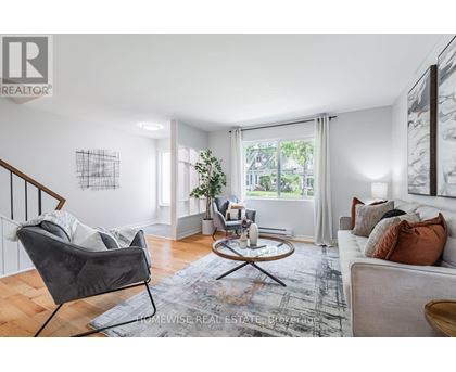 A living room with a grey chair and a white couch.