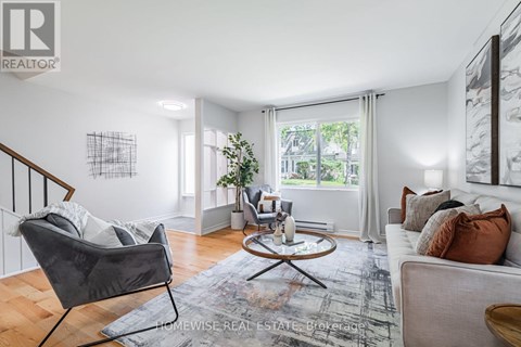 A living room with a grey chair and a white couch.