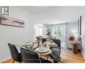 A dining room with a glass table and chairs.