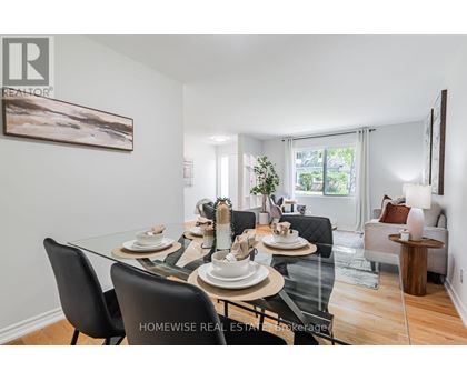 A dining room with a glass table and chairs.