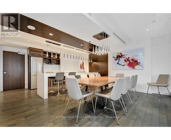 A modern dining room with a wooden table and chairs.