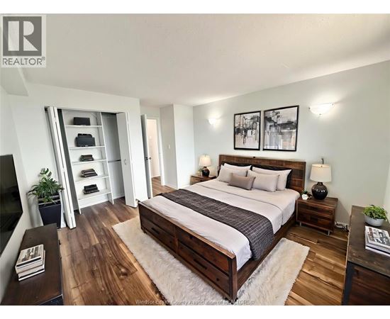 A bedroom with a large bed, a dresser, and a mirror.