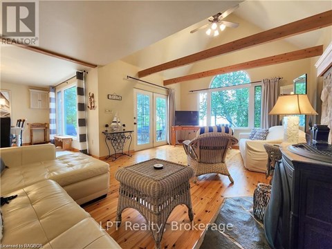 A living room with a white couch and a wooden floor.