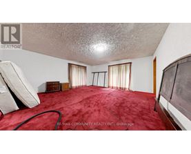 A bedroom with a red carpet and a white ceiling.