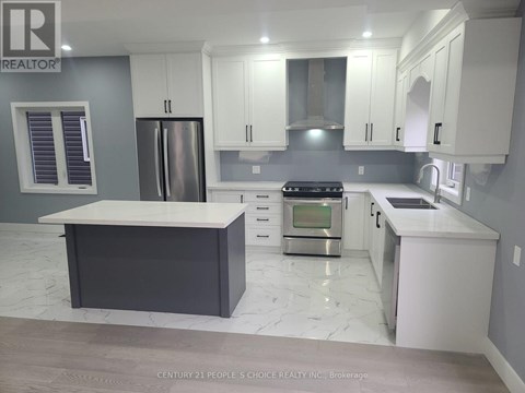 A modern kitchen with white cabinets and a marble countertop.