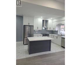 A modern kitchen with a large island and stainless steel appliances.