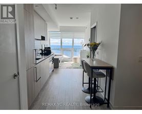 A kitchen with a bar stool and a view of the water.