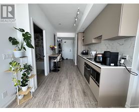 A kitchen with a white counter top and a plant on it.