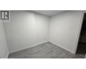 A room with a grey floor and white walls.