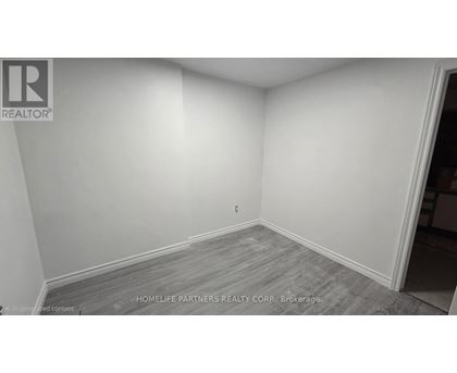 A room with a grey floor and white walls.