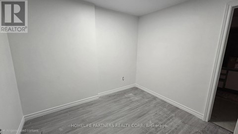 A room with a grey floor and white walls.