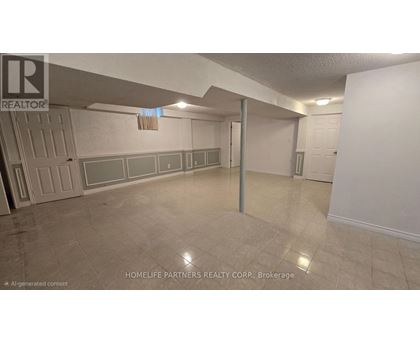 A room with a white wall and a grey floor.