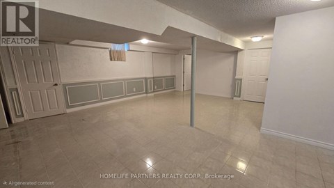 A room with a white wall and a grey floor.