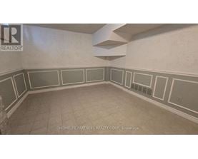 A room with a wall that has a border of squares and rectangles.