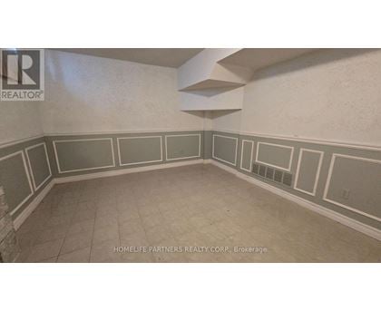 A room with a wall that has a border of squares and rectangles.